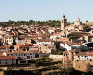 Vista general de Valjunquera con casas tradicionales y torre de iglesia en el Matarraña